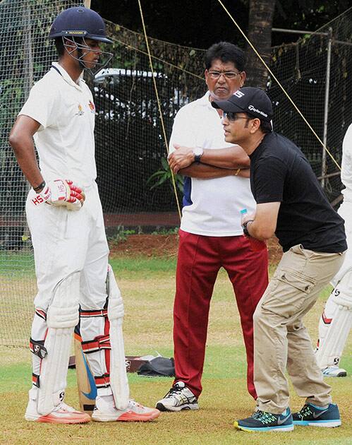 Master Blaster Sachin Tendulkar giving playing tips to a Mumbai player as the Mumbai coach Chandrakant Pandit looks on at BKC ground, in Mumbai .