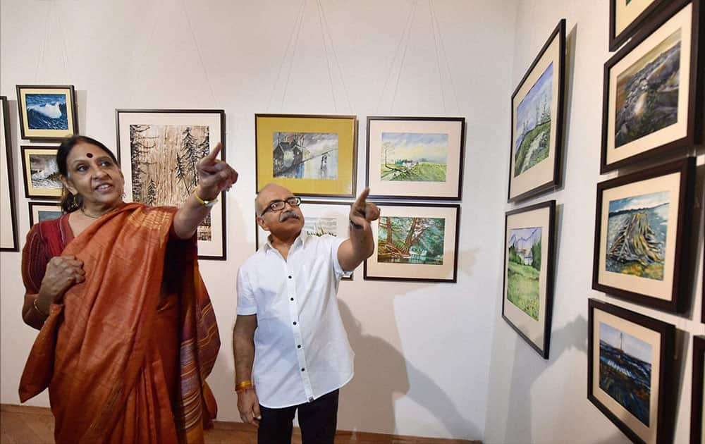 Bureaucrat Rakesh Agarwal showing his paintings to Jaya Jaitly at the exhibition titled Nature-Scapes in New Delhi.