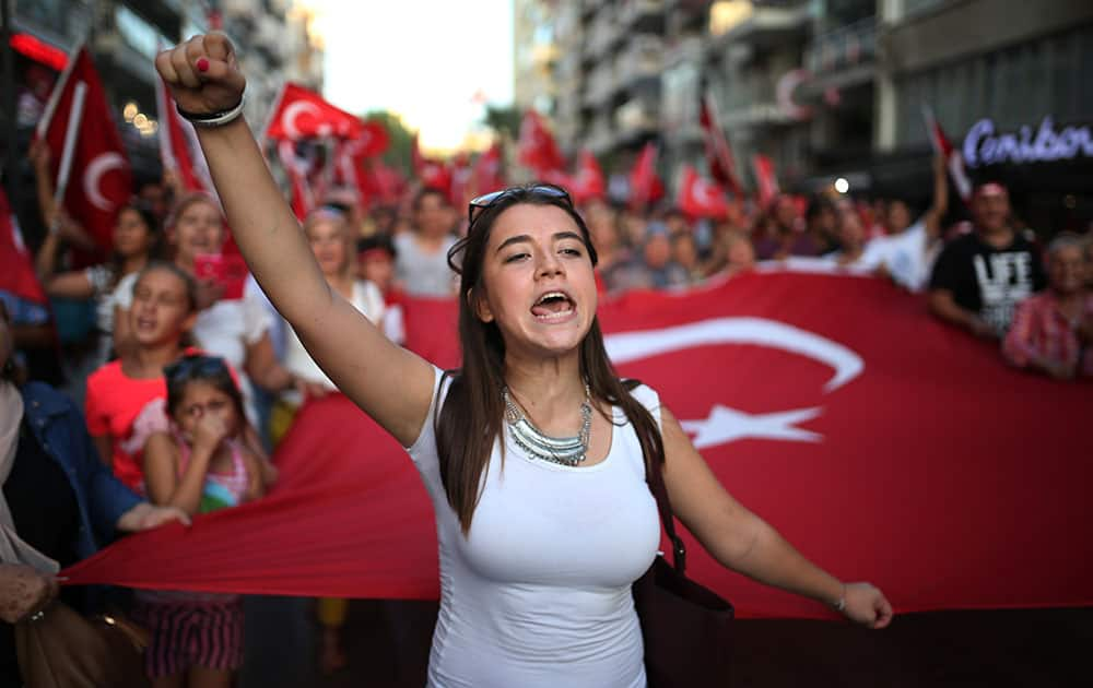 Thousands of people march to protest against the deadly attacks on Turkish troops, in Izmir, Turkey.