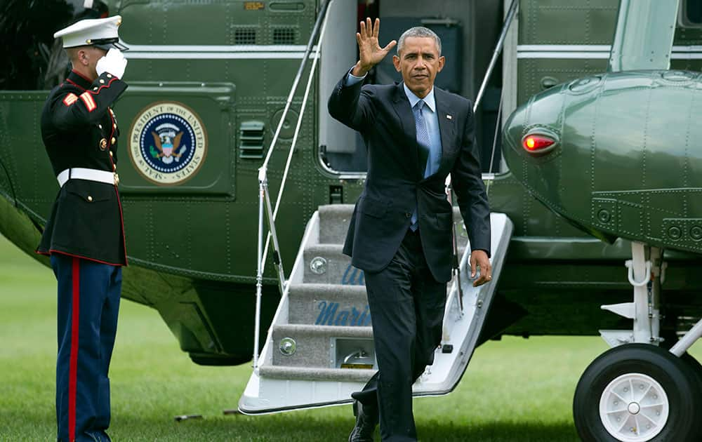 President Barack Obama waves upon arrival at the White House in Washington.