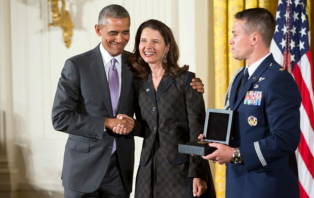 President Barack Obama awards the 2014 National Humanities Medal to Clemente Course In The Humanities of Annandale-On-Hudson, N.Y., and is received by Academic Director Marina van Zuylen during a ceremony in the East Room at the White House in Washington