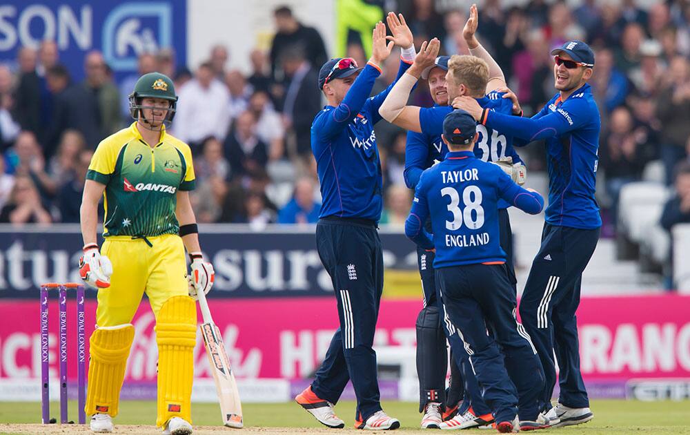 England's David Willey celebrates with teammates after trapping Australia's Steven Smith, LBW for 5 during the One Day International cricket match between England and Australia at Headingley cricket ground in Leeds, England.