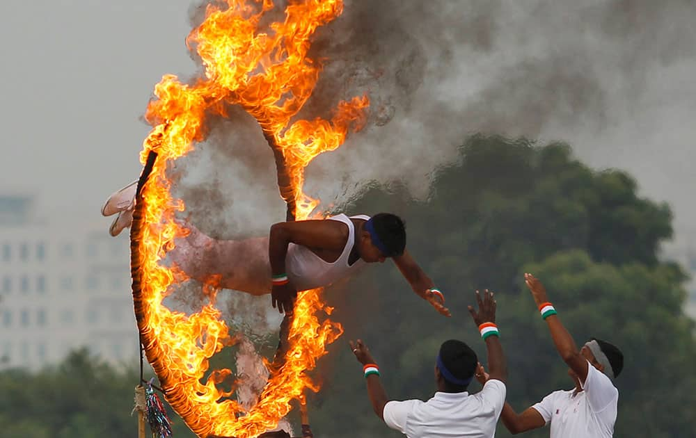 A cadet leaps through a ring of fire at a combined display with trainees from the Officers Training Academy (OTA) in Chennai.