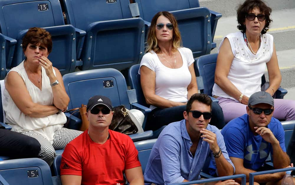 Olympic gymnast Nadia Comaneci watches a quarterfinal match between Victoria Azarenka, of Belarus, and Simona Halep, of Romania, at the U.S. Open tennis tournament.