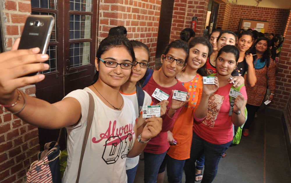 Students wait in a queue to cast their votes during DU elections in New Delhi.