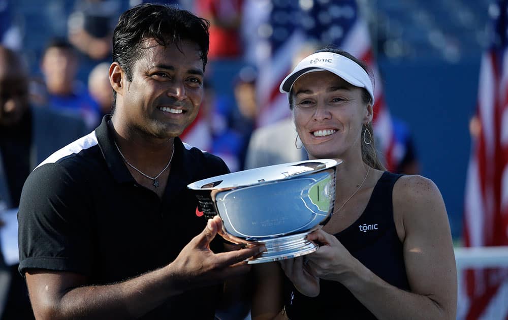 Leander Paes and Martina Hingis, of Switzerland, pose for a photo after winning the mixed doubles final match against Bethanie Mattek-Sands and Sam Querrey, of the United States, at the US Open tennis tournament.