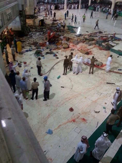 Pilgrims and first responders gather at the site of a crane collapse that killed dozens inside the Grand Mosque in Mecca, Saudi Arabia.