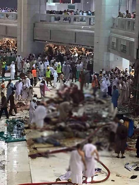 Pilgrims and first responders gather at the site of a crane collapse that killed dozens inside the Grand Mosque in Mecca, Saudi Arabia.