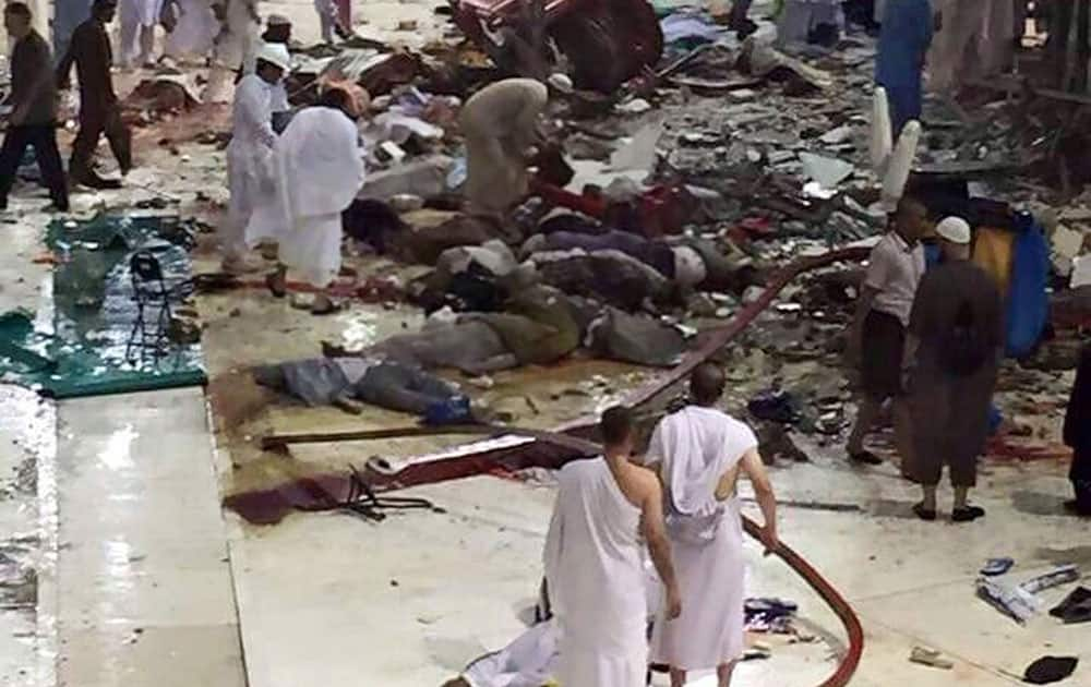 Pilgrims and first responders gather at the site of a crane collapse that killed dozens inside the Grand Mosque in Mecca, Saudi Arabia.