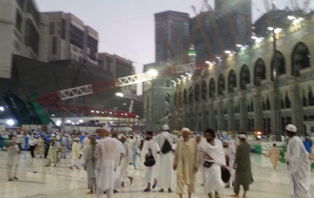 Pilgrims and first responders gather at the site of a crane collapse that killed dozens inside the Grand Mosque in Mecca, Saudi Arabia.