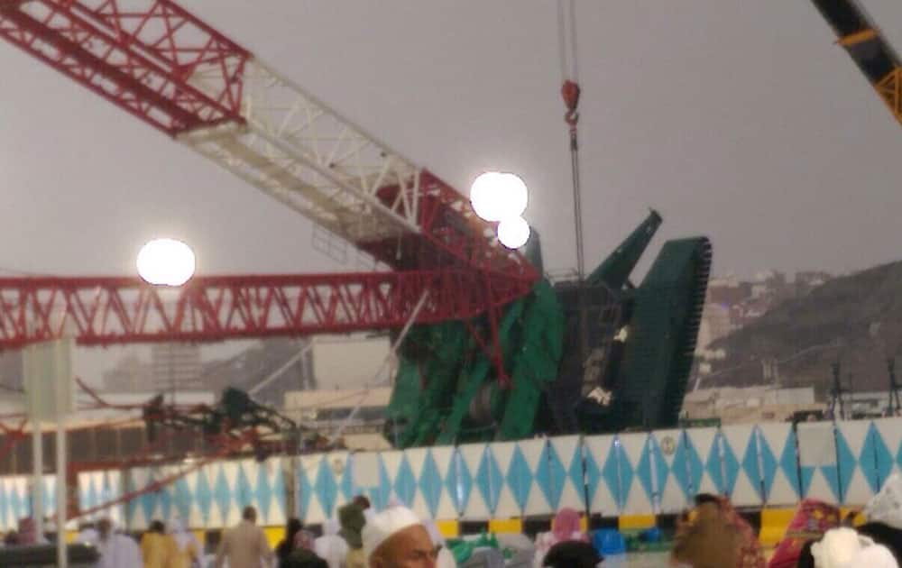 Pilgrims and first responders gather at the site of a crane collapse that killed dozens inside the Grand Mosque in Mecca, Saudi Arabia.