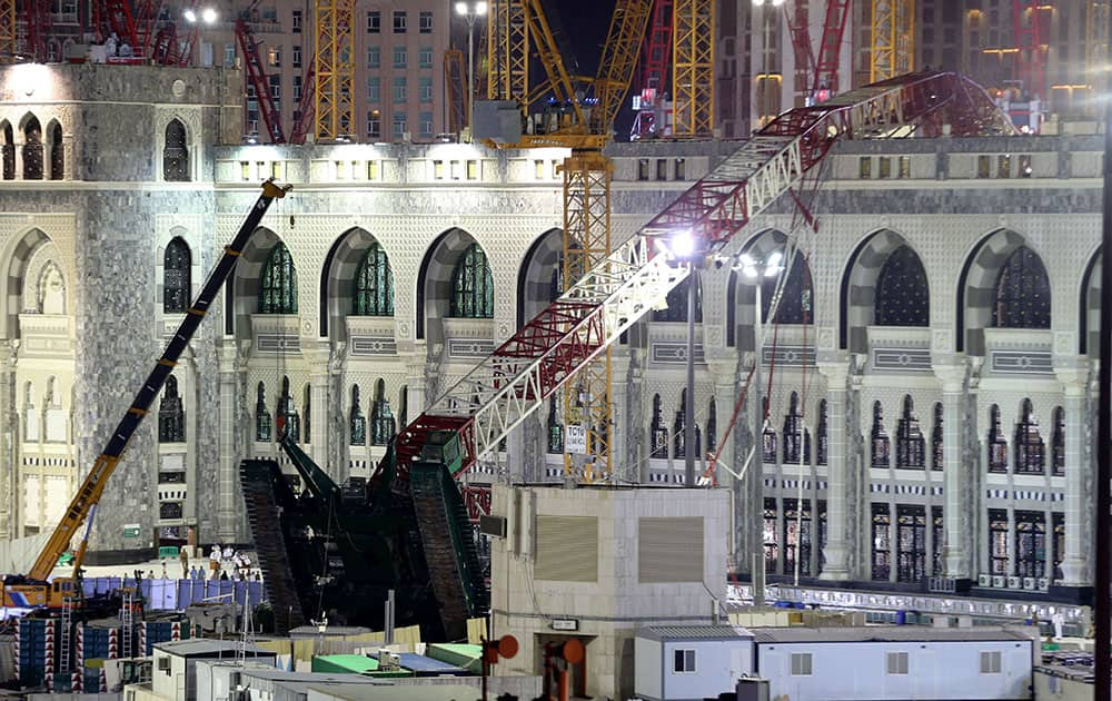 A towering construction crane, center, is seen collapsed over the Grand Mosque, in Mecca, Saudi Arabia.