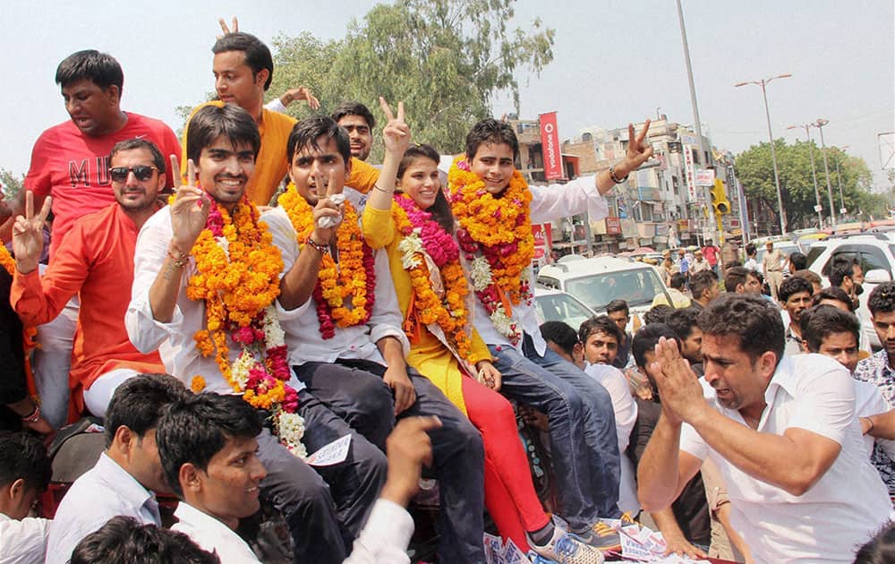 ABVP panel candidates celebrate their victory in the Delhi University Students Union elections in New Delhi.