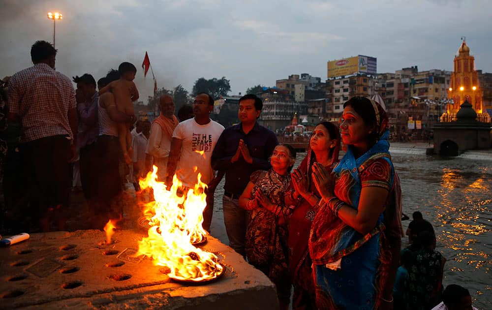 Indian devotees pray on the banks of the Godavari River during Kumbh Mela, or Pitcher Festival, in Nasik, India.