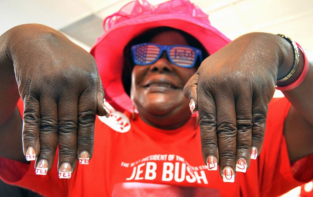 Lucy Orlando shows her Jeb Bush manicure during Republican presidential candidate and former Florida Gov. Jeb Bush's opening of his Miami campaign office.