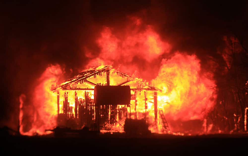 A home and shop are burned by the Valley fire as it enters Middletown,Calif., in Lake County.