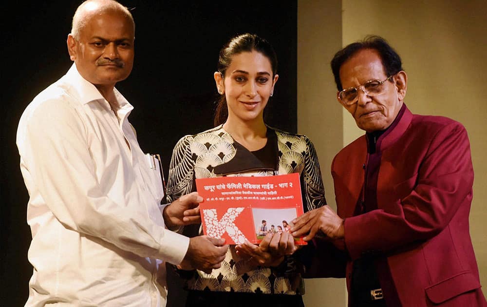 Bollywood actress Karishma Kapoor during the launch of the book Family Medical Guide written by Dr.O.P.Kapoor(R) in the presence of dean at J.J Hospital Dr TP Lahane (L) in Mumbai.