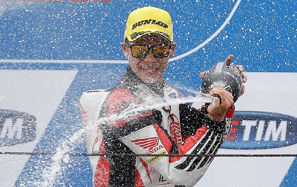 Kalex rider Takaaki Nakagami, of Japan, celebrates on the podium his third place during the San Marino Moto 2 grand prix at the Misano circuit, in Misano Adriatico, Italy.