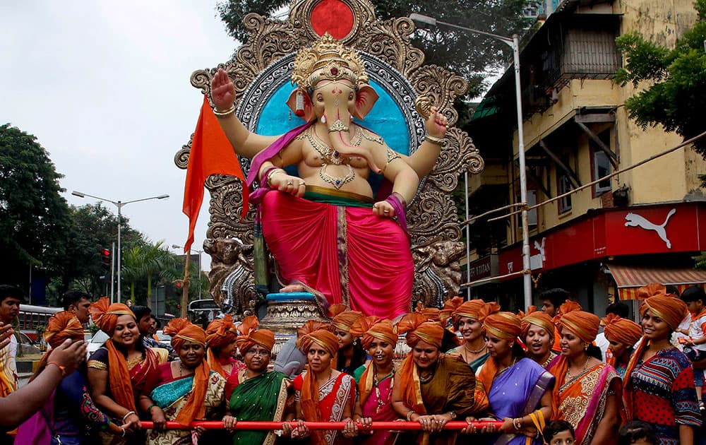 Devotees transport an idol of elephant headed Hindu god Ganesha from a workshop to a worship venue ahead of the Ganesh Chaturthi festival in Mumbai, India.