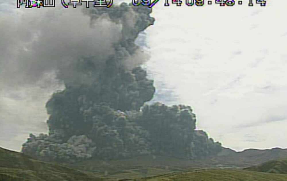In this image taken from a surveillance camera observed from Kusasenri and released by Japan Meteorological Agency, a column of black smoke rises from Mount Aso, Kumamoto prefecture, southern Japan.