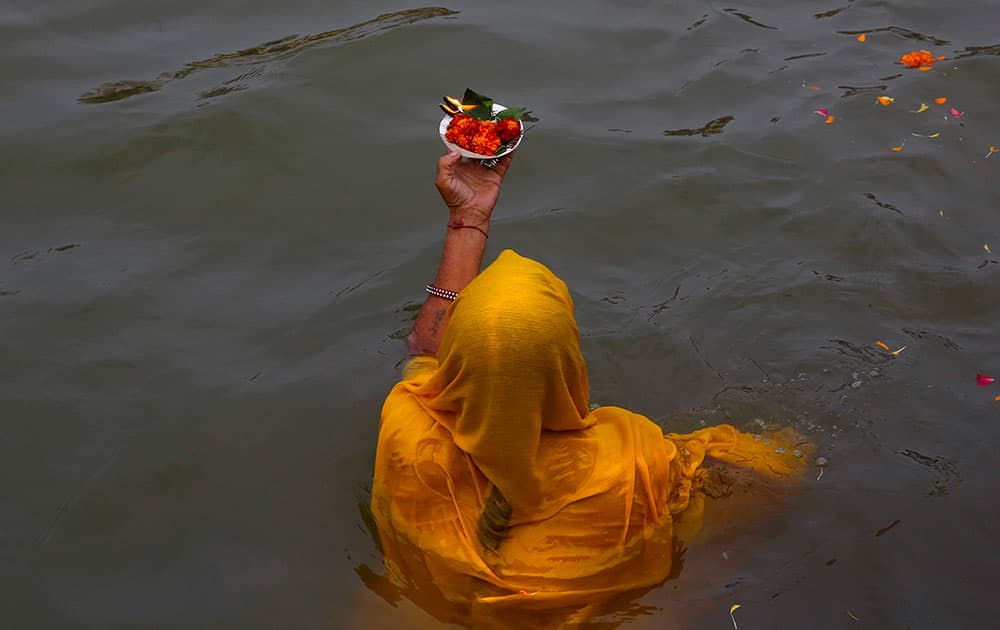 An Indian woman devotee prays after a holy dip on the second 'shahi snaan' or royal bath in the river Godavari during the ongoing Kumbh Mela or Pitcher Festival, in Nasik, India.