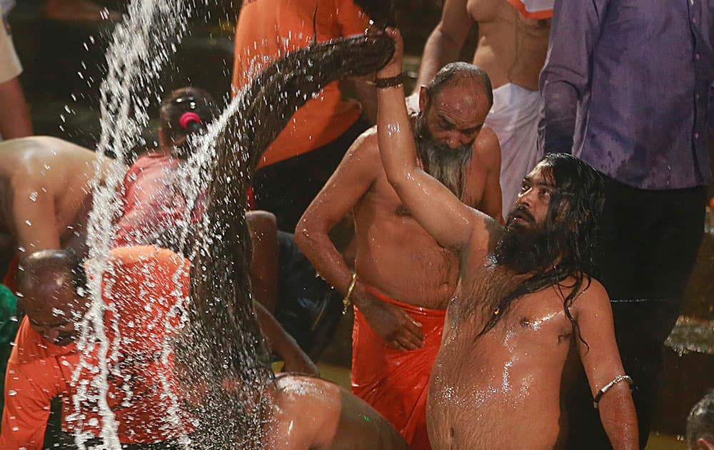 Naga sadhu, or naked Hindu holy men, take a holy dip in the Godavari River during Kumbh Mela, or Pitcher Festival, at Trimbakeshwar in Nasik, India.