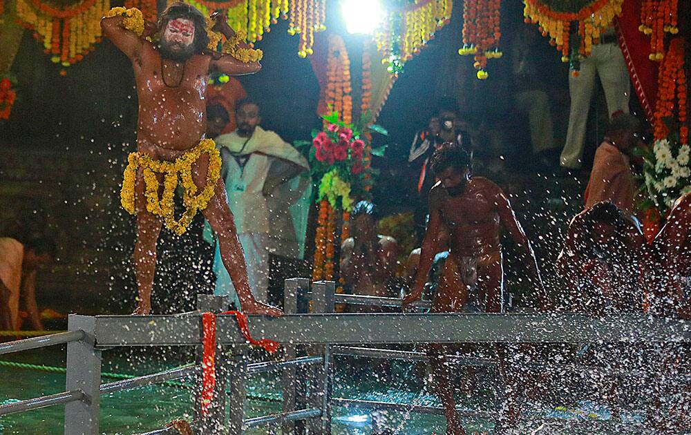 A Naga sadhu, or naked Hindu holy man, prepares to take a holy dip in the Godavari River during Kumbh Mela, or Pitcher Festival, at Trimbakeshwar in Nasik, India.