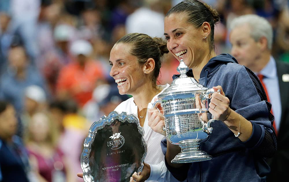 Roberta Vinci, of Italy and Flavia Pennetta, of Italy, pose for photos after Pennetta beat Vinci in the women's championship match of the U.S. Open tennis tournament.