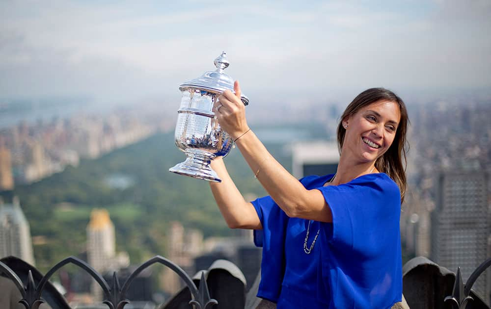 Flavia Pennetta, of Italy, holds the U.S. Open tennis women's singles championship trophy during a visit to the Top of the Rock Observation Deck at Rockefeller Center in New York.