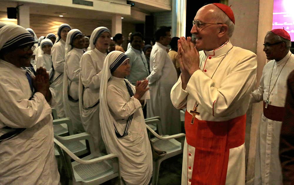 Cardinal Fernando Filoni, head of the Vatican's Congregation for the Evangelization of Peoples, greets nuns of the Missionaries of Charity, the order founded by Mother Teresa, in Kolkata.