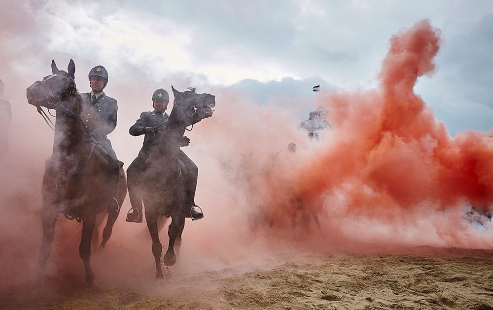 Smoke from grenades shrouds horses and riders during a practice session for members of the Dutch cavalry in Scheveningen, Netherlands.