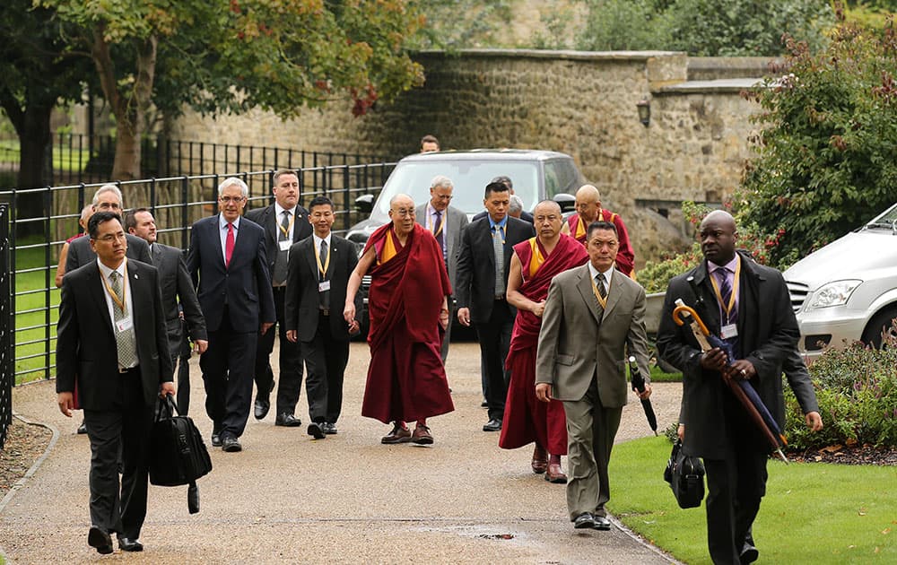 Tibetan spiritual leader the Dalai Lama walks during a visit to Magdalen College, Oxford University, at the start of a 10-day visit to the Britain, in Oxford, England.