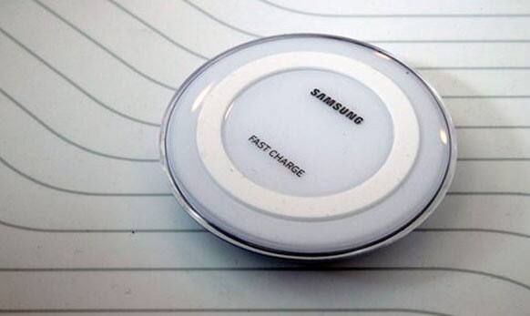 The Samsung fast charging wireless charger is on display during a Samsung presentation.