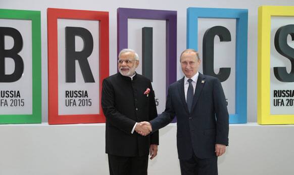 Indian Prime Minister Narendra Modi, left, and Russian President Vladimir Putin shake hands.