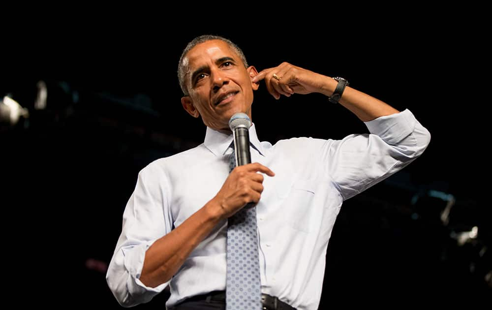 President Barack Obama points to his ear as he talks about how some perceive education as just pouring information into your head as he speaks at a town hall with high school juniors, seniors and their parents at North High School in Des Moines, 2015, to discuss college access and affordability. 