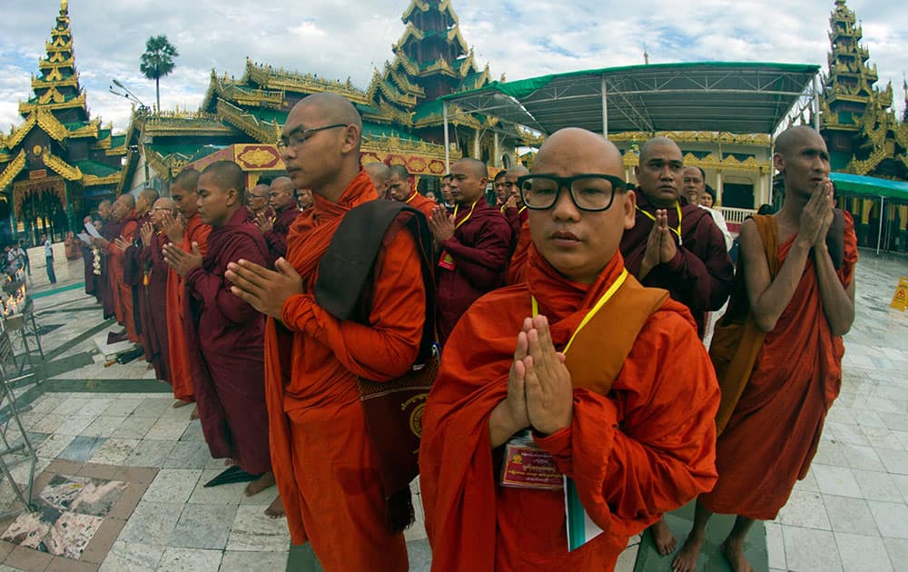 Myanmar Buddhist monks pray at Shwedagon Pagoda before a ceremony to welcome the approval of “Marriage Law”, at parliament.