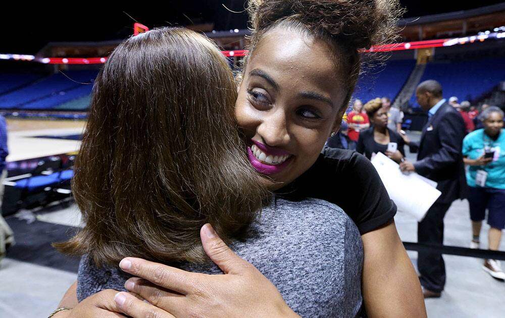 Tulsa Shock's Skylar Diggins, right, hugs season-ticket holder Lisa Clark following a WNBA basketball game against the Phoenix Mercury in Tulsa, Okla. 