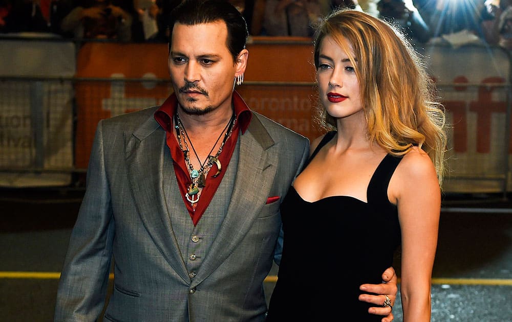 Actor Johnny Depp and wife Amber Heard pose for photographs on the red carpet for the new movie 'Black Mass' during the 2015 Toronto International Film Festival.