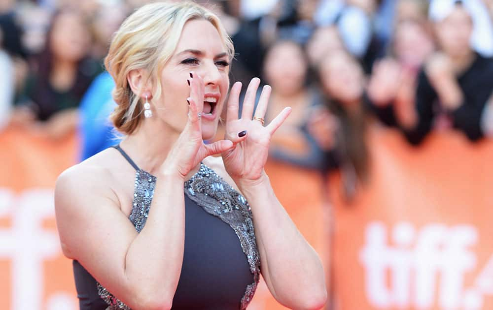 Actor Kate Winslet shouts to fans as she arrives on the red carpet at the gala for the film 