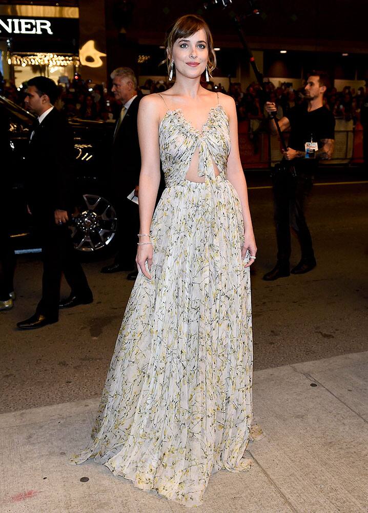 Actress Dakota Johnson poses for photographs during a premiere for 'Black Mass' during the Toronto International Film Festival at the Elgin Theatre, in Toronto.