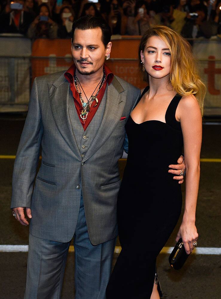 Actor Johnny Depp and wife Amber Heard pose for photographs on the red carpet for the new movie 'Black Mass' during the 2015 Toronto International Film Festival.