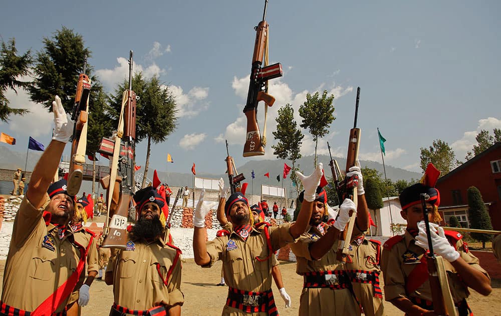 Newly recruits of Jammu and Kashmir police celebrate after their graduation parade in Manigham, northeast of Srinagar.