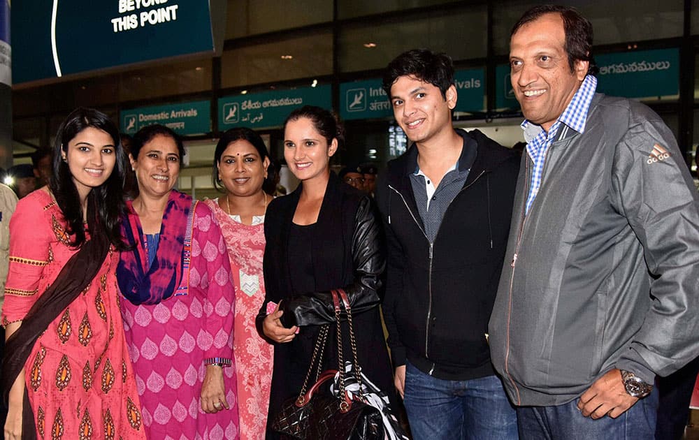 Tennis Star Sania Mirza with family members on her arrival after winning her second consecutive Grand Slam title US Open women’s doubles at Rajiv Gandhi International Airport in Hyderabad.