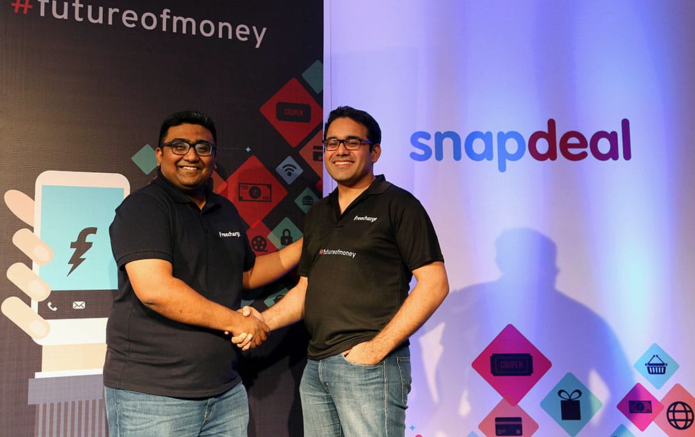 Kunal Bahl, right, co-founder and Chief Executive Officer (CEO) of Snapdeal shakes hands with Kunal Shah co-founder and CEO of FreeCharge after the launch of “Digital Wallet” in Bangalore.