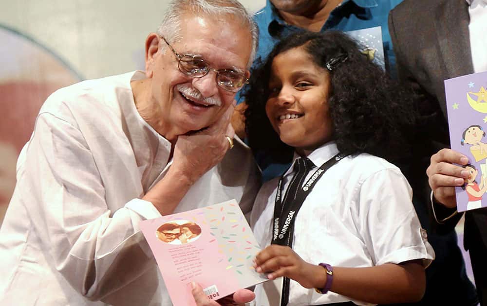 Poet and lyricist Gulzar with a school girl during a book launch event in Thane, Mumbai.