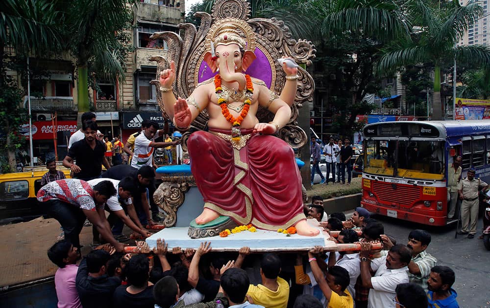 Devotees carry an idol of Hindu god Ganesha from a workshop to a worship venue ahead of the Ganesh Chaturthi festival in Mumbai.