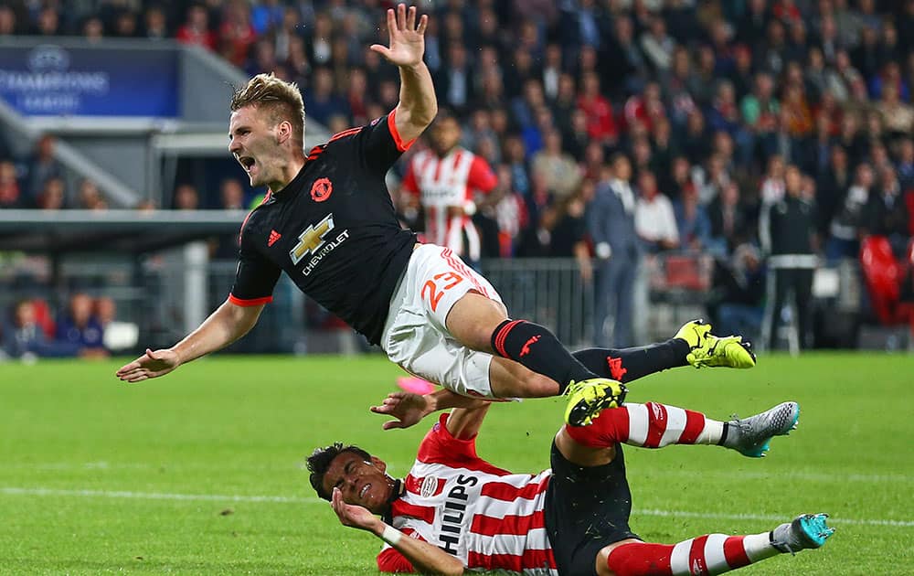 Manchester United’s Luke Shaw, top, is tackled by PSV's Hector Moreno, resulting in a double fracture of Shaw's right leg, during the Champions League Group B soccer match between PSV and Manchester United at Philips stadium in Eindhoven, Netherlands.