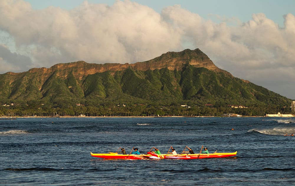 A outrigger canoe paddles past Diamond Head mountain, in Honolulu. A powerful magnitude-8.3 earthquake hit off Chile's northern coast Wednesday night putting Hawaii under a tsunami advisory.