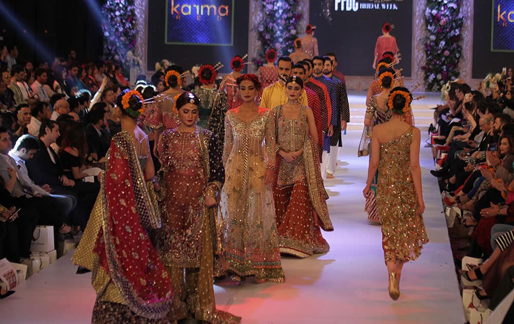 Pakistani models present creations by designer Karma Red during the Pakistan Fashion Design Council Bridal Week in Lahore, Pakistan.