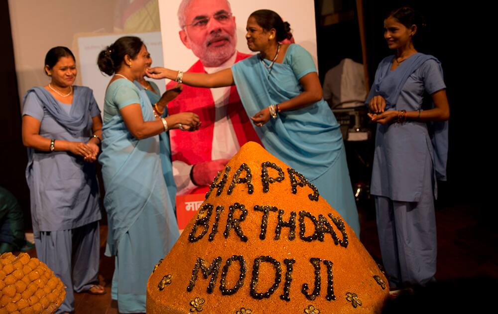 Members of India's non-governmental organization Sulabh International celebrate Prime Minister Narendra Modi's birthday in New Delhi.